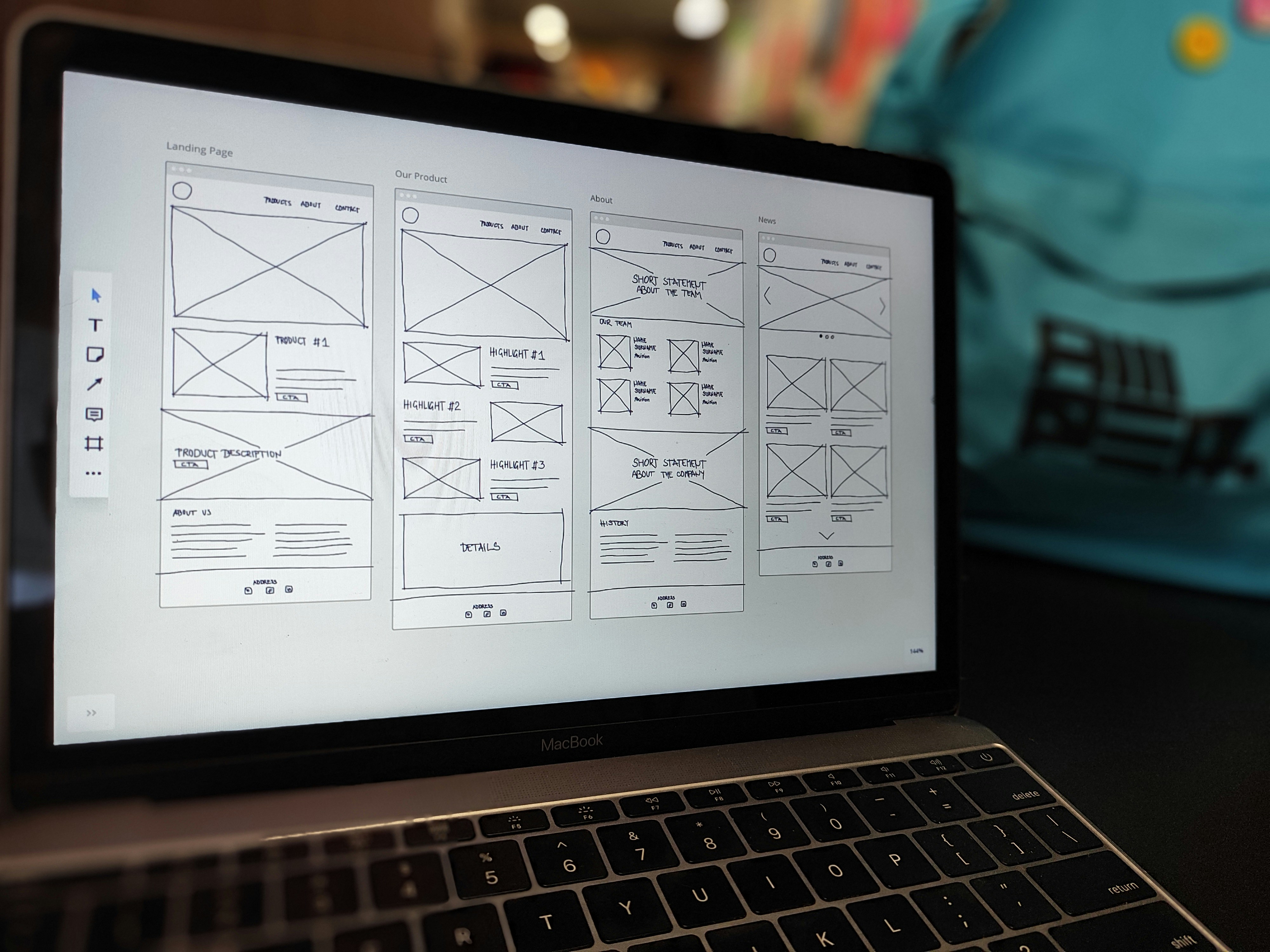 Laptop with website wireframes on the screen.